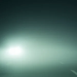 Car headlights shining through thick fog on highway.