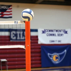 Volleyball net with school colors and commitment banner.